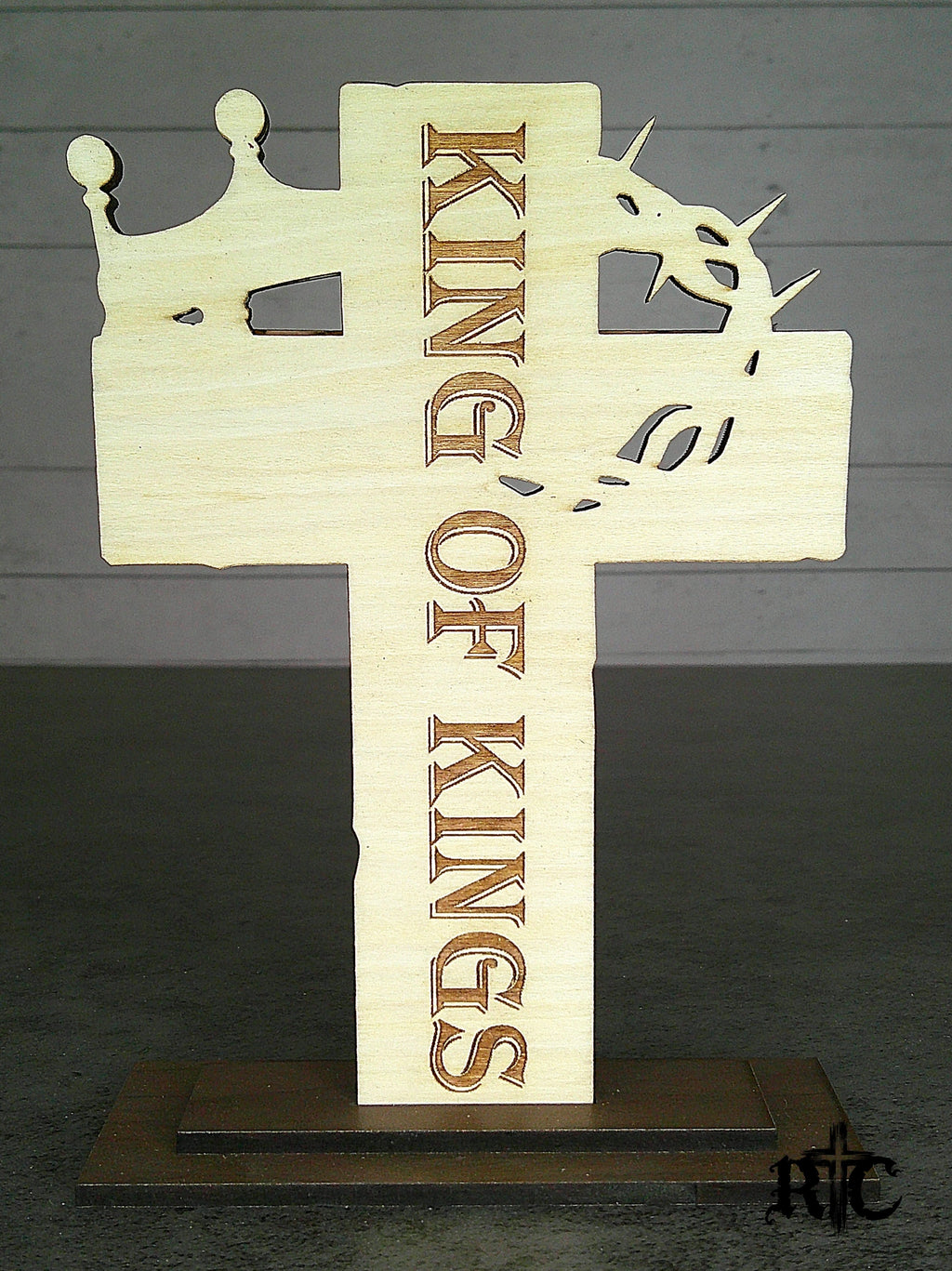 The back of a wooden cross with a crown of thorns and a royal crown made to set on a desktop or shelf
